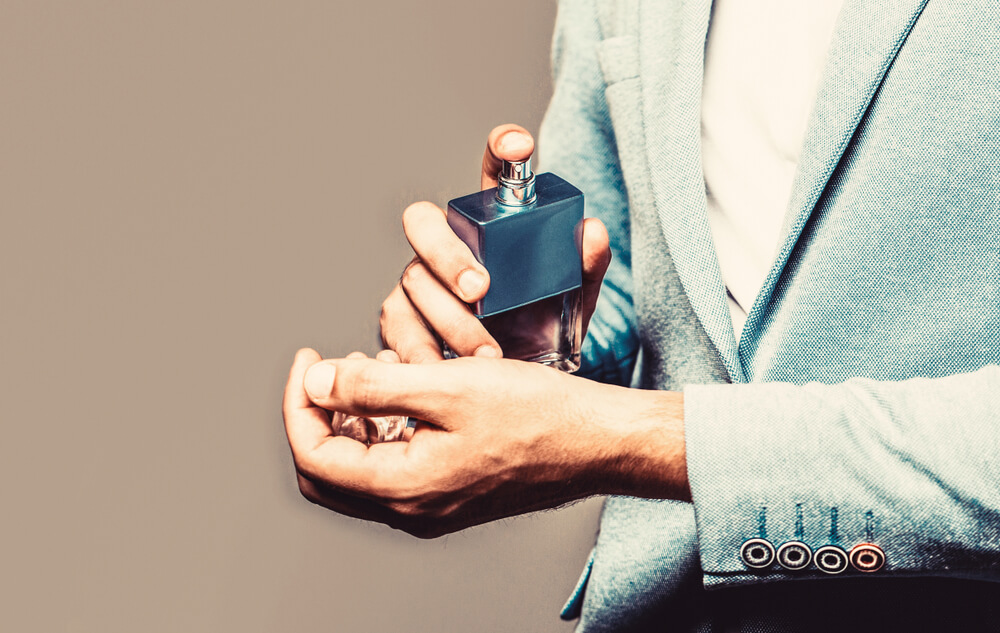 Man applying fragrance to wrist