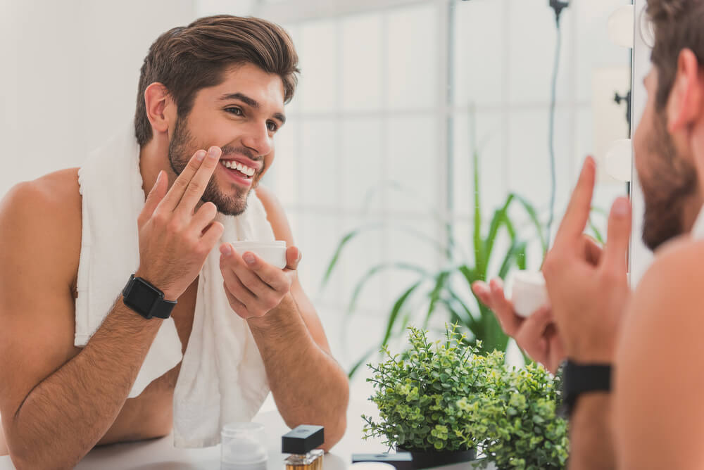 Man applying skin cream