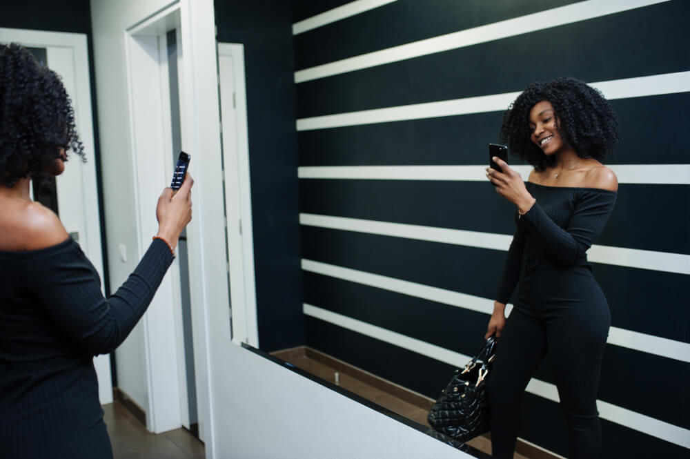 Woman with natural hair taking selfie