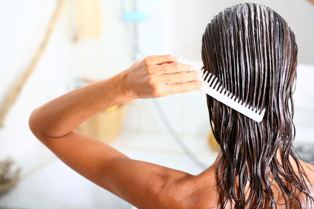 Woman applying hair mask