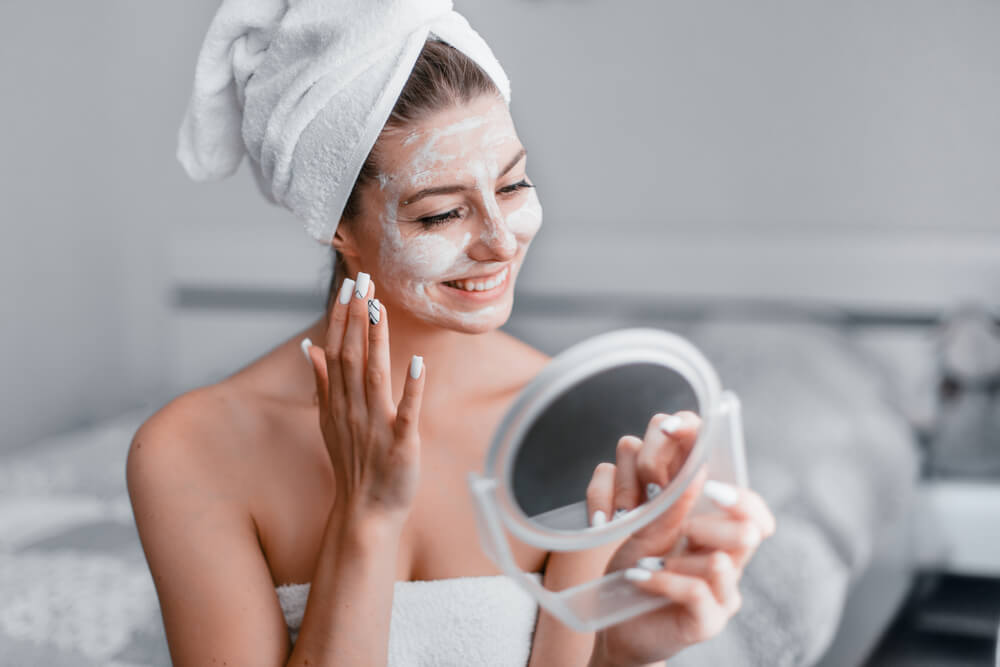 Woman applying face mask