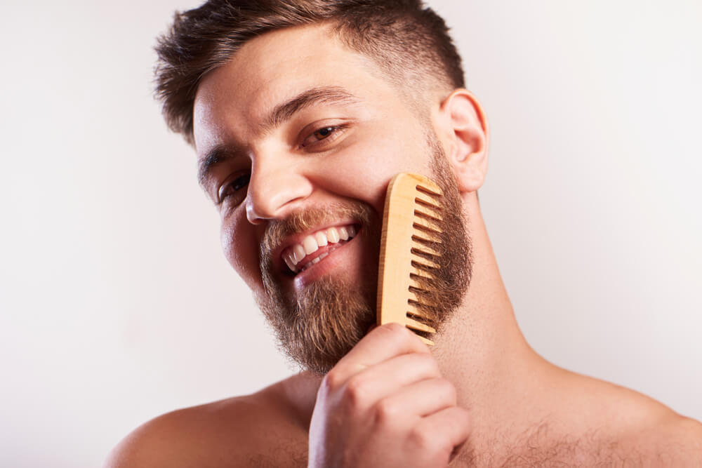 Man using beard comb