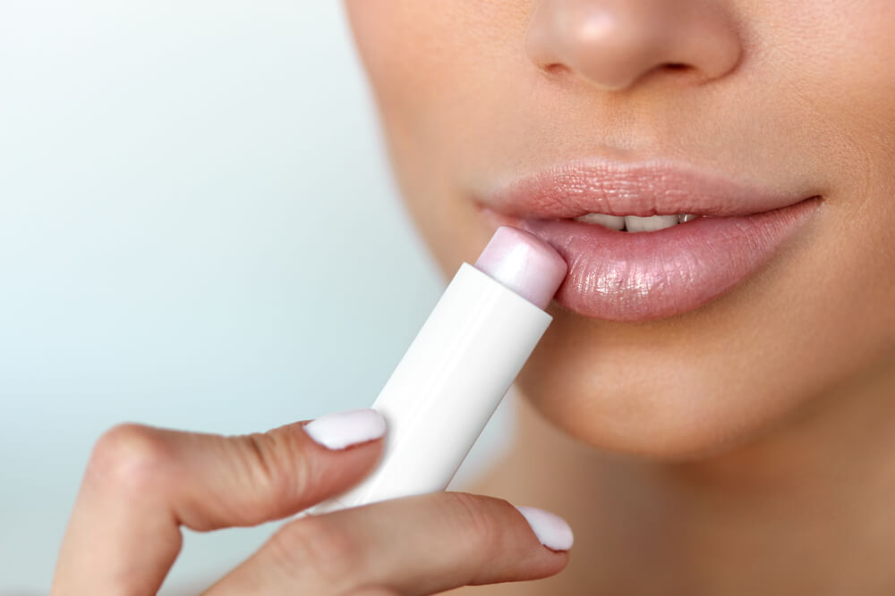 Woman using lip balm