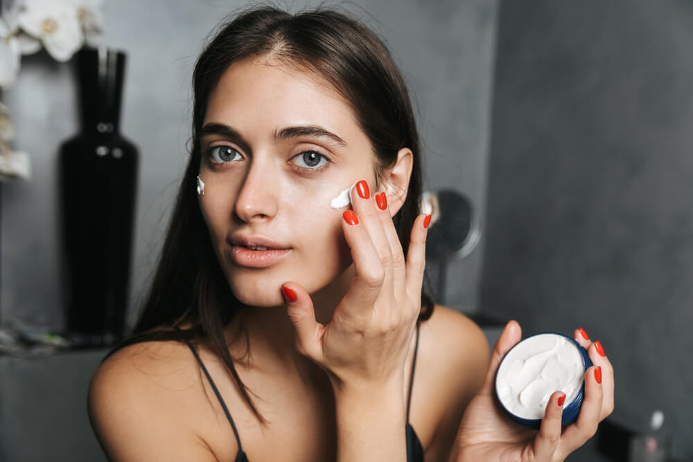 Woman applying face cream