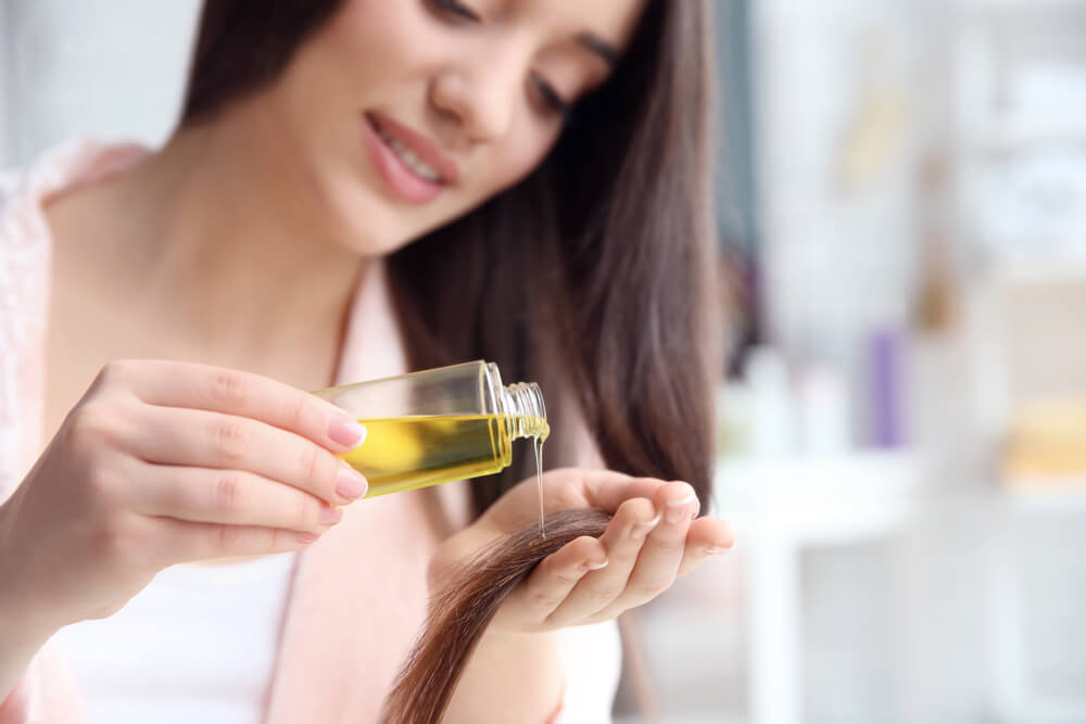 Woman using hair oil