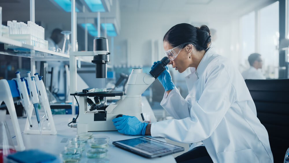 woman using microscope