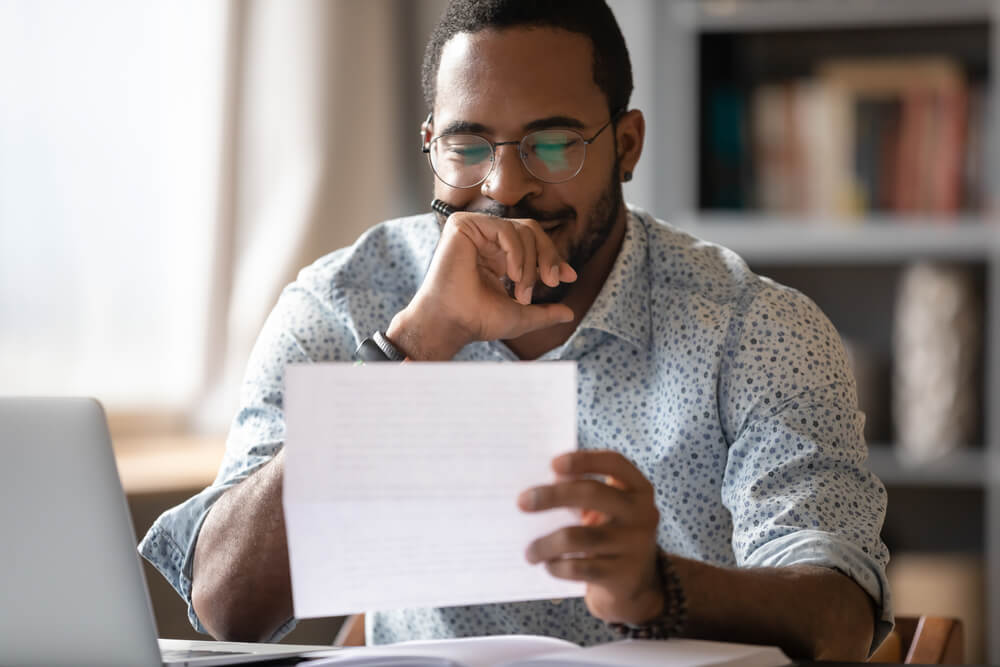 man looking at paper