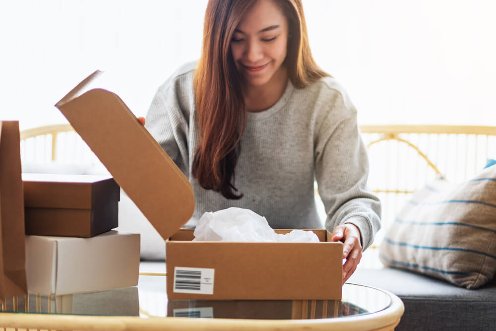 woman opening box